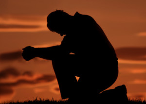 man-praying-on-one-knee