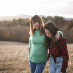 Teenage Girl And Mother On A Walk In Nature